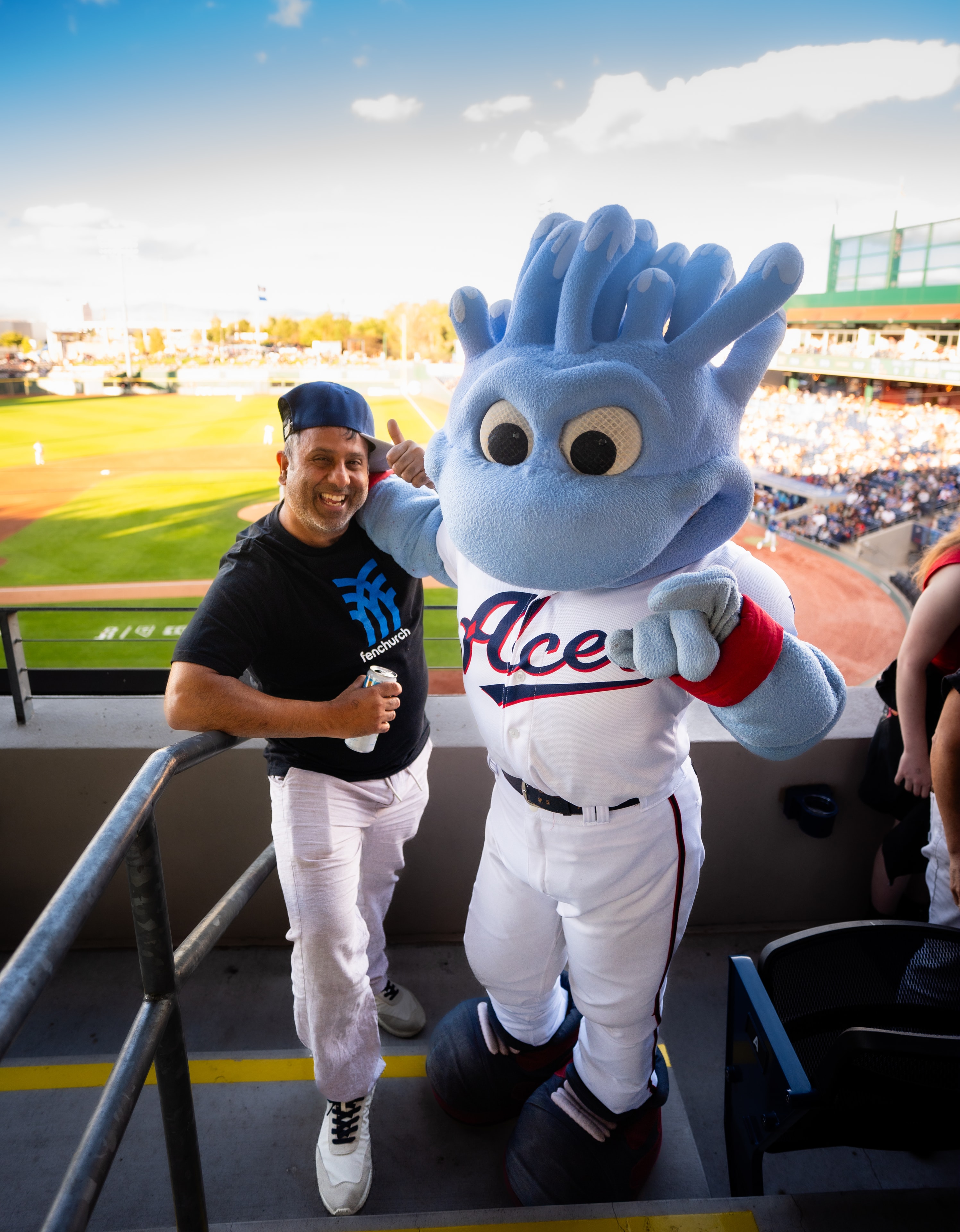 Member with the Reno Aces mascot at the baseball game